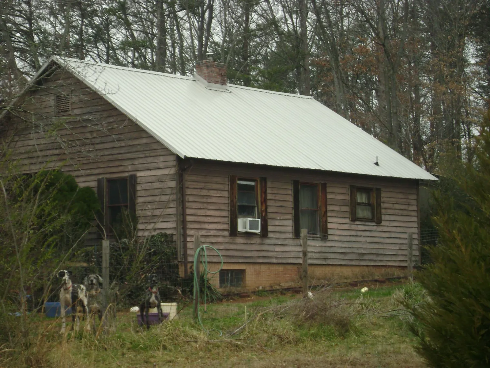 White metal roof on an old wood sided farmhouse, from a Metal Roof Installation job in Meyersdale